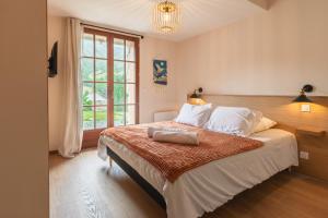 a bedroom with a large bed and a window at Les Chalets de l'Ours in Cauterets