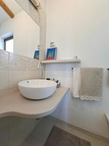 a white bathroom with a sink and a mirror at Casa Rosa Istria in Kućibreg +39 photos