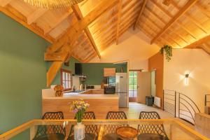 a kitchen and living room with wooden ceilings at Les Chalets de l'Ours in Cauterets