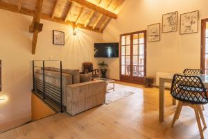 a living room with a couch and a table at Les Chalets de l'Ours in Cauterets