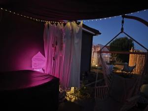 a bedroom with a bed with a pink light at Cocoon Reflex'Ô in Escurolles +7 photos