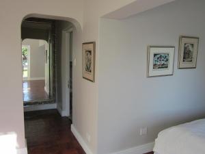 a bedroom with a bed and a mirror on the wall at The Gregoire Boutique Villa in Hermanus