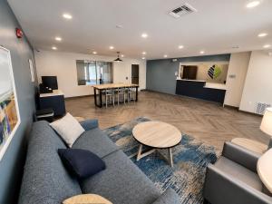 a living room with a couch and a table at WoodSpring Suites Jackson Hub City in Jackson