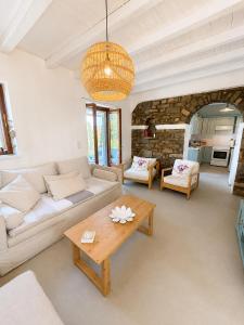 a living room with a couch and a table at villa kite paros in Pounda
