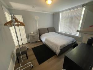 a small bedroom with a bed and a desk at Vancouver east downtown queen bed room share bathroom in Vancouver