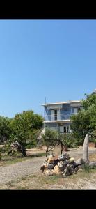 a house with a pile of rocks in front of it at The Beach House in Vasilika