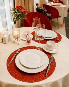 a table with plates and wine glasses on it at Guest house TWINS in Tashkent