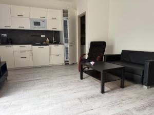 a living room with a couch and a table at Apartman VIKY in Bartovice