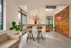 a kitchen with a counter and stools in a room at Duck House in Da Thien +21 photos