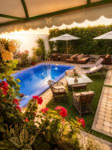a backyard with a pool with a table and chairs at Guest house TWINS in Tashkent