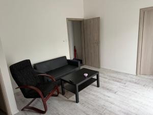a living room with a couch and a coffee table at Apartman VIKY in Bartovice