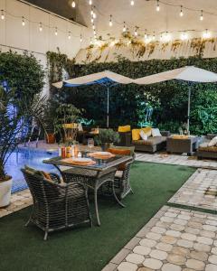 a patio with a table and chairs and a pool at Guest house TWINS in Tashkent