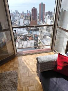 a room with a large window with a view of a city at Espacio San Martin - Departamento en plena peatonal con Seguridad 24 hs in Santa Fe +9 photos