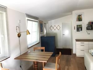 a living room with a table and a couch at Ferienhaus Himmelblau in Waldsieversdorf +7 photos