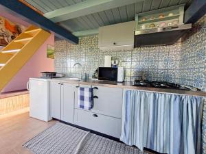 a kitchen with white cabinets and a sink at Apartment Rosa Istria in Buje