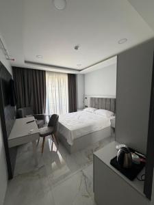 a hotel room with a bed and a desk at Sesse suit in Istanbul +2 photos