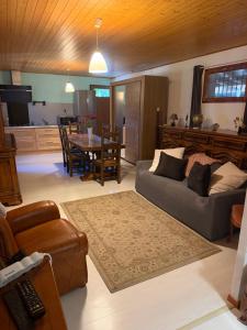 a living room with a couch and a table at Studio privé in Cazilhac