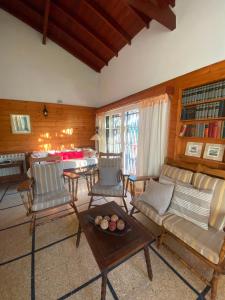 a living room with a couch and chairs and a table at Cruz del Sur in Pinamar