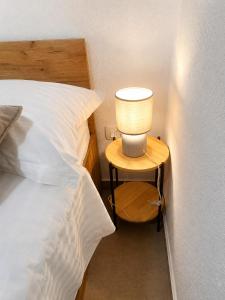 a lamp on a night stand next to a bed at Christina in Otok