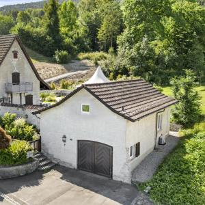 an overhead view of a white house with a garage at peaceful tiny house near forest in Rorschacherberg