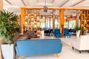 a lobby with a blue couch and chairs at Mozza Beach Resort in York