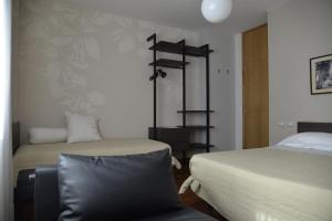 a bedroom with two beds and a chair in it at Bed And Breakfast 22 Garibaldi Home in Riccione