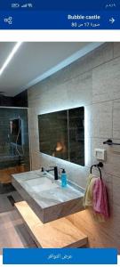 a bathroom with a large bath tub with a sink at Bubble Castel Boutique Hotel in Kerak