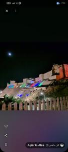 a picture of a city at night with a fence at Bubble Castel Boutique Hotel in Kerak