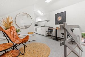 a living room with a mirror and a table and chairs at peaceful tiny house near forest in Rorschacherberg