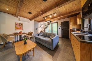 a kitchen and living room with a couch and a table at Chalet - AQUA MARIA RESORT in Veľaty