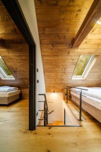 a room with two beds and two windows at Chalet - AQUA MARIA RESORT in Veľaty +23 photos