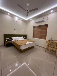 a bedroom with a bed and a ceiling fan at Ayra Inn in Cochin