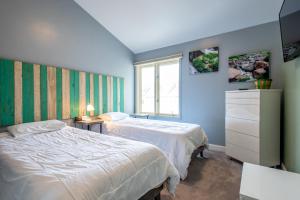 a bedroom with two beds and a window at The Woods 8 in Copper Mountain