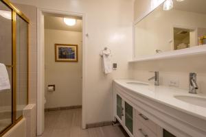a bathroom with two sinks and a mirror at The Woods 8 in Copper Mountain +27 photos