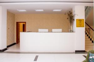 a lobby with a reception desk in a building at Hotel Kilimanjaro in Luanda