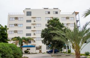 a white building with trees in front of it at Hotel Kilimanjaro in Luanda