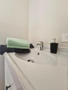 a bathroom sink with a green towel on top of it at oud in Zonnebeke