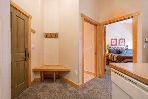 a kitchen and living room with a door and a table at Copper Springs Lodge 426 in Copper Mountain