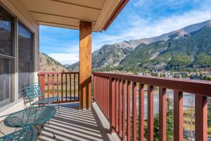 a balcony with chairs and a view of mountains at Copper Springs Lodge 426 in Copper Mountain +35 photos