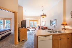 a kitchen and living room with a sink and a bed at Copper Springs Lodge 426 in Copper Mountain