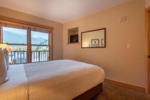 a bedroom with a bed and a large window at Copper Springs Lodge 107 in Copper Mountain