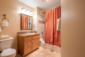 a bathroom with a toilet and a sink and a shower at Copper Springs Lodge 107 in Copper Mountain