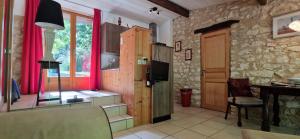 a living room with a tv and a table and a window at Cezanne in Douzains