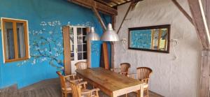 a dining room with a wooden table and chairs at Gauguin in Douzains