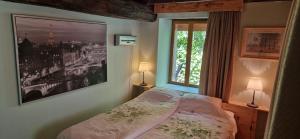 a bedroom with a bed and a large window at Monet in Douzains +35 photos