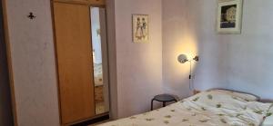 a small bedroom with a bed and a mirror at Gauguin in Douzains +31 photos