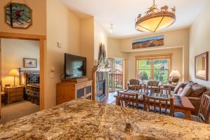 a living room with a television and a living room with a fireplace at Copper Springs Lodge 433 in Copper Mountain