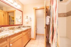 a bathroom with two sinks and a large mirror at Copper Springs Lodge 433 in Copper Mountain