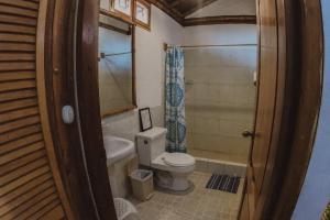 a bathroom with a toilet and a tub and a sink at Hostal Rosa Mística in Montañita +110 photos