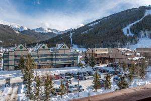 a resort with a parking lot in the snow at Copper Springs Lodge 404 in Copper Mountain